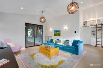 Loft has access to the covered deck. To the right, a custom-made library wall shelving system - stunning!