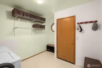 Oversized laundry room is the perfect mudroom to store buddy boots and backpacks!