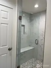 Beautiful large tiled shower with bench