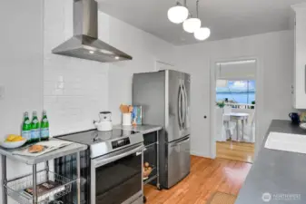 Peek views & new stainless steel appliances including induction stove.