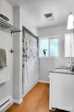 Main floor bath with new lighting, RH mirror & nice vanity. A slightly different window would allow the green of the backyard to enter without giving up privacy.