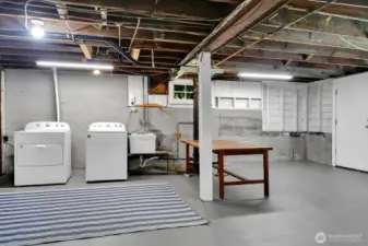 Big easy laundry area with door leading to backyard entry. Good potential to make this basement more living space.