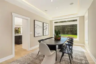 Light-filled dining room featuring elegant lighting, a spacious layout—perfect for entertaining.