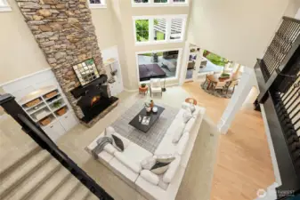 Elegant great room with stone fireplace, custom details, and soaring ceilings.