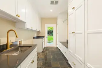 Spacious laundry-mudroom room w/ new cabinetry  & direct access to backyard jacuzzi.