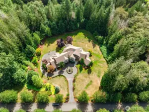 Stunning estate nestled on private 3.840-acre lot, featuring elegant architecture, lush landscaping, & serene surroundings.