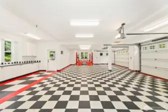 Oversized 5-car garage features abundant built-in storage and a heavy-duty 4-post lift rated to 9,000 lbs—ideal for auto enthusiasts