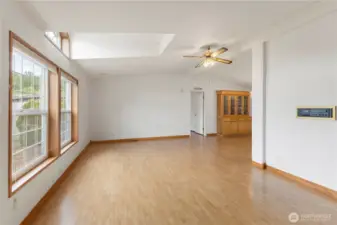 Bright living room featuring laminate flooring across the main spaces