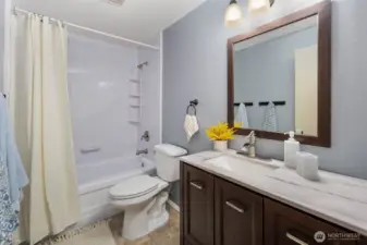 Hallway full bathroom with a tub.