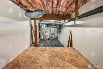 Crawl space with furnace and tankless water heater.