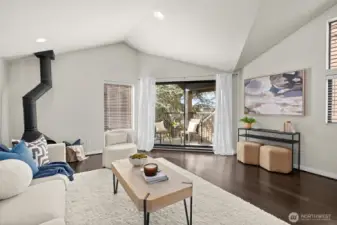 Living room with dramatic vaulted ceilings and view deck.