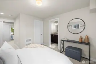 Primary Suite with bath to the right, walk-in closet in the center, and second bedroom across the way.