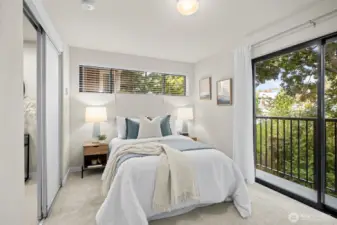 The second bedroom is on the same level as the Primary and has a slider/balcony that overlooks the shady backyard.
