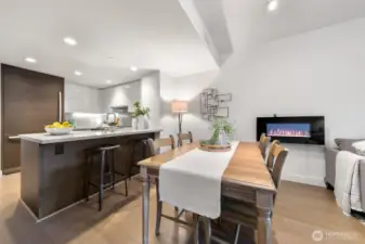 Dining area with electric fireplace.