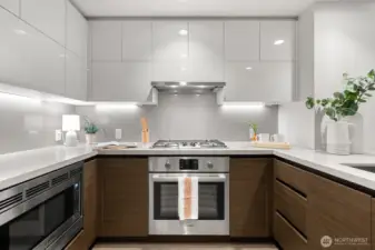 Microwave, oven and cabinets.