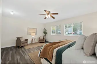 Spacious primary bedroom was previously converted from a garage. 2 large windows bringing in lots of natural western light. Room features ceiling fan and brand new flooring, en-suite full bathroom and walk-in closet.