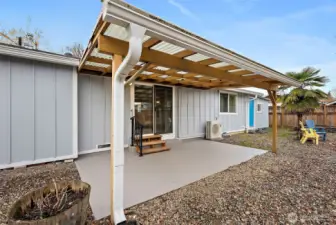 Enter the covered back patio from sliding door off living room. Attached shop also allows access to the backyard (blue door).