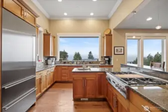The kitchen was designed with a chef in mind! There is an abundance of granite counters as well as natural shaker-style cherry cabinets. The Miele 6 burner cooktop has a griddle as well.