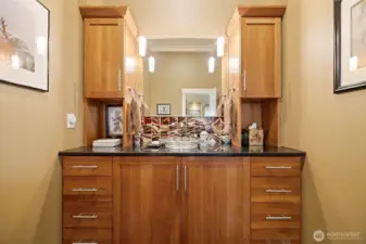 The powder room that is adjacent to the de/office has a gorgeous vanity with a vessel sink that lights up from below.