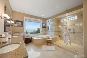 The primary bathroom is also very spacious with a deep soaking tub and oversized 3-head shower that take in the stunning views, and a separate toilet room.