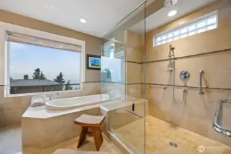 Another view of the oversized shower and the deep soaking tub that are all tiled in travertine.