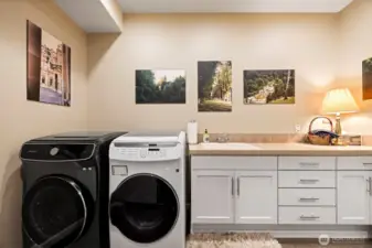 Even the laundry room is large! It has a deep laundry sink and cabinetry as well as other storage that was behind the photographer.