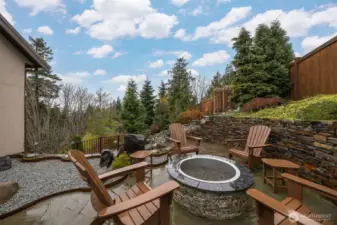 The firepit is just off the office on the rear side of the home and adjacent to the waterfall in the extremely private rear yard.