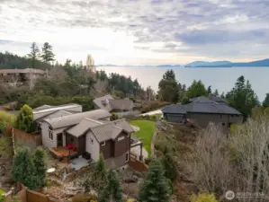 Looking down at the rear patio and water feature with the firepit that is all accessible from the office/den.