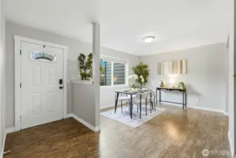 Step inside to a light-filled entry where the open kitchen and dining areas create an inviting first impression.