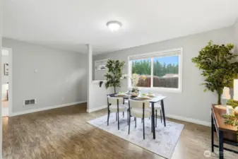 Sunny dining area open to the entry and kitchen, creating a bright and welcoming gathering space.