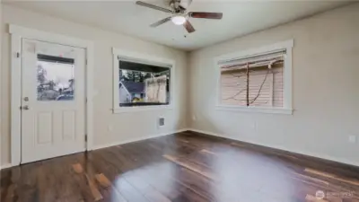 Bright open-concept living room with great natural light, offering a comfortable space for relaxing or entertaining.