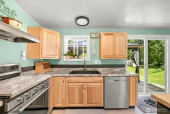 Bright kitchen with garden views, updated finishes, and functional workspace.