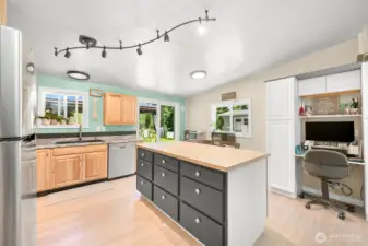 Expansive butcher block island with ample prep space and open-concept kitchen layout.