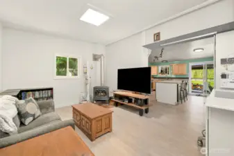 Spacious living room with flexible layout, featuring built-in workspace and abundant natural light