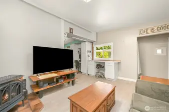 Spacious living room with flexible layout, featuring built-in workspace and abundant natural light.