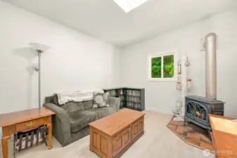 Cozy living area with freestanding stove, creating a warm and inviting atmosphere year-round.