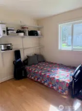 Versatile second bedroom ideal for guests, office, or additional storage, with built-in shelving and natural light.