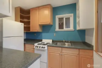 Cottage (North) home upper level kitchen opens to living room.