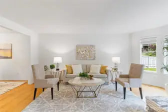 Living room with bay window that lets in the natural light.