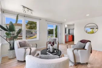 Sliding doors lead to wrap around deck with city views.