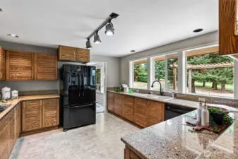 Kitchen with windows overlooking the stunning landscape and golf course.