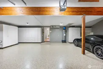 3 car garage with epoxy flooring and additional shelving.