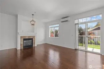Bright open living room with vaulted ceilings, skylights, and cozy gas fireplace