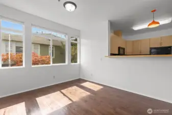 Bright open living room with vaulted ceilings, skylights, and cozy gas fireplace