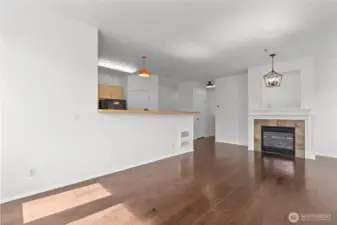 Bright open living room with vaulted ceilings, skylights, and cozy gas fireplace