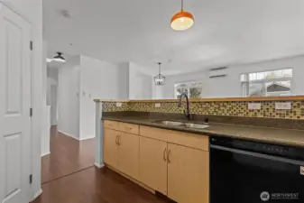 Modern kitchen with granite countertops, stainless steel appliances, and eating ba