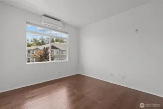 Comfortable primary bedroom with walk-in closet and abundant natural light