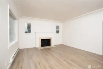 The spacious living room features a charming fireplace and excellent natural light. With fresh paint and new trim and flooring, this home makes an excellent starter!