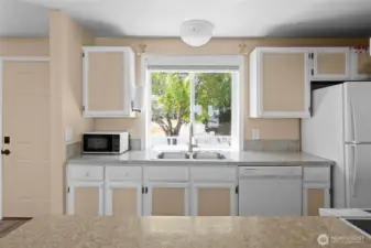 Kitchen window adds light to the work area, looking out at NE 4th Street.
