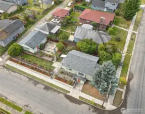 The corner lot includes a 2-car garage and fenced garden bordered by roses. There's plenty of space for parking along the street in this neighborhood with paved sidewalks, and a planting strip along the curb.